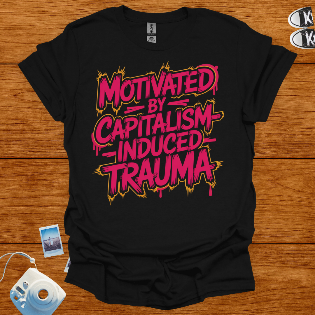 Black t-shirt with pink and yellow text on a wooden surface