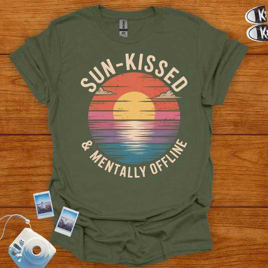 Green t-shirt with 'Sun-Kissed & Mentally Offline' design on a wooden surface